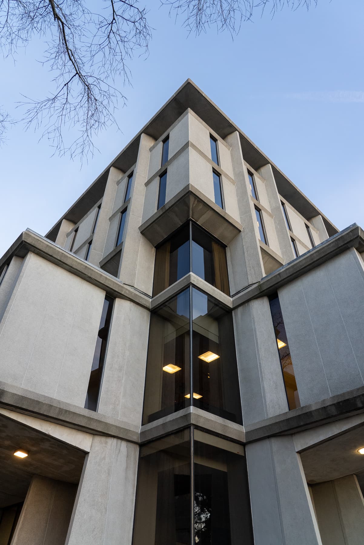 A corner of the John D. Rockefeller Jr. Library. Large structural beams run vertically along its side while the cantilevered second floor juts out on both sides.